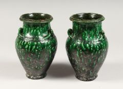 A PAIR OF EARLY TREACLE GLAZE VASES.