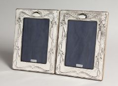 A PAIR OF SILVER PHOTOGRAPH FRAMES IN Art Nouveau style. 7.5ins x 5.5ins.