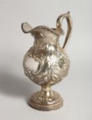 AN R & W WILSON 19TH CENTURY PHILADELPHIA SILVER JUG repousse with flowers and scrolls 8ins high,