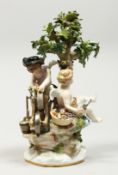 A GOOD MEISSEN PORCELAIN GROUP, CUPID BENEATH A TREE sharpening an arrow and a cherub holding an