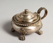 A GEORGE IV SILVER CIRCULAR MUSTARD POT AND COVER with gadrooned edge on four feet. London 1825.