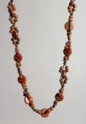 A RHINO BEAD NECKLACE with numerous small beads