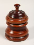 A LIGNUM VITA CIRCULAR BOX AND COVER 7ins