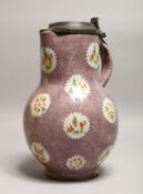 AN EARLY; DELFT POTTERY JUG, with pewter lid, peuce ground with panels of stylised flowers. 10.25ins
