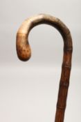 A RUSTIC WALKING STICK 2ft 8ins long