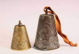 TWO BRONZE QAJAR CATTLE BELLS - each with raised lion decoration one with calligraphy, 11cm &