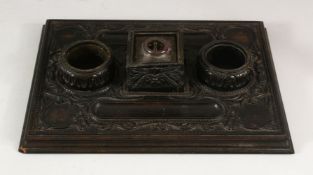 A 19TH CENTURY SRI LANKAN OR CEYLONESE CARVED EBONY DOUBLE SIDE DESK STAND, with cut glass central