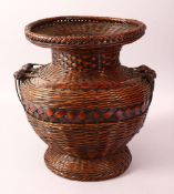 A JAPANESE MEIJI PERIOD WOVEN IKEBANA BASKET VASE - the woven basket with twin handles and a
