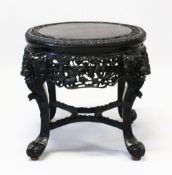 A SUPERB CHINESE CARVED EBONY STAND, the top border carved with bamboo, cherry blossom and lilies