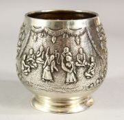 A SMALL EASTERN SILVER PEDESTAL BOWL, embossed decoration depicting figures and trees, 8cm high.
