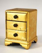 A SMALL JAPANESE GILT LACQUER CHEST, comprising three small drawers, supported on four bracket feet,