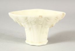A CHINESE BLANC DE CHINE / DEHUA PORCELAIN LIBATION CUP - with moulded floral decoration,10.5cm