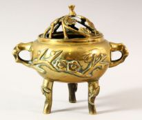 AN EARLY 20TH CENTURY CHINESE POLISHED BRONZE TWIN HANDLE CENSER AND COVER, supported on tripod