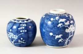 TWO BLUE AND WHITE PRUNUS GINGER JARS, lacking covers,14cm and 10cm.