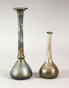 TWO EARLY SLENDER GLASS VESSELS, possibly roman, 10cm and 16cm high.