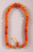 A GOOD SET OF CHINESE OR ISLAMIC AMBER PRAYER BEADS, the string comprising of 36 beads and toggle