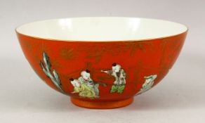 A GOOD CHINESE CORAL RED CIRCULAR BOWL, painted with numerous children playing, 21cm diameter.