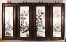 A SET OF FOUR CHINESE FAMILLE ROSE PORCELAIN FRAMED PANELS - each depicting figures seated in