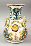 A TURKISH OTTOMAN KUTAHYA POTTERY MOSQUE LAMP - with triple handles and raised flora, with floral