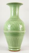 A VERY GOOD LARGE CHINESE CELADON VASE, with panels of flowers and fluted base, 64cm high.