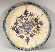 A RARE 16TH CENTURY INDIAN MULTAN POTTERY DISH, the centre painted with a floral spray within a