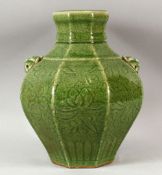 A CHINESE OLIVE GLAZED GREEN GLAZED PORCELAIN JAR - decorated with scraffito decoration and twin