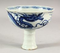 A CHINESE BLUE AND WHITE PORCELAIN STEM CUP, decorated with a dragon, 13cm diameter.