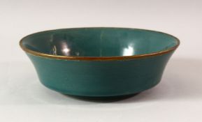A CHINESE SONG STYLE CELADON BOWL, the centre carved with calligraphy, 22cm diameter.