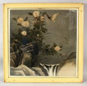 AN EARLY 20TH CENTURY JAPANESE PAINTING ON TEXTILE, depicting birds and flowers by a waterfall,