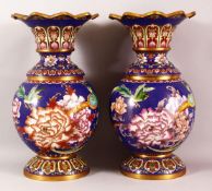 A PAIR OF CHINESE CLOISONNE VASES - with a deep royal blue ground depicting native flora and