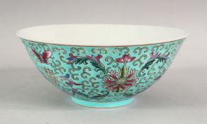 A CHINESE TURQUOISE GROUND PORCELAIN BOWL, the exterior decorated with flowers, 16cm diameter.