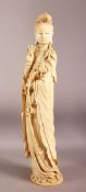 A SUPERB LARGE CHINESE IVORY TUSK CARVING OF A STANDING GUANYIN, the right hand raised, her left