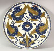 A TURKISH IZNIK POTTERY PLATE - decorated with floral pattern, 30cm