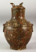 A CHINESE ARCHAIC STYLE BRONZE LIDDED TWIN HANDLE VESSEL, incised with calligraphy, 30cm high.