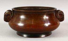 A CHINESE BRONZE TWIN HANDLE CENSER - with twin ram head decoration - base with a 16 character