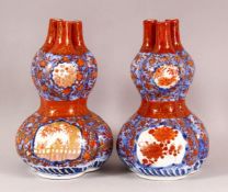 A PAIR OF ORIENTAL IMARI PORCELAIN GOURD VASES, each with three openings to the neck, in the form of