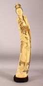 AN IMPRESSIVE LARGE CHINESE IVORY TUSK CARVING OF A STANDING GUANYIN, her left hand raised, her