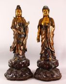 A LARGE PAIR OF CHINESE GILT BRONZE FIGURES OF DEITYS - one of guanyin, the other of buddha, both in