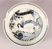 A CHINESE BLUE & WHITIE PORCELAIN PLATE, decorated with a bird and flora, the underside with a six
