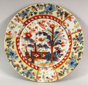 A JAPANESE PORCELAIN DISH, decorated in the imari palette, red mark to base, 23cm diameter.
