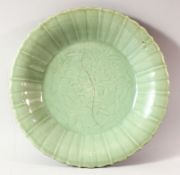 A CHINESE CELADON LOBED DISH, possibly 18th century, the centre incised with flowers, with early