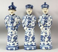 THREE LARGE CHINESE BLUE & WHITE PORCELAIN EMPEROR FIGURES, each stood with decorated robes with