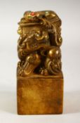 A CHINESE BRONZE SEAL, in form of a lion dog, inset with semi precious stones, 12cm high.