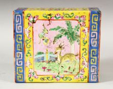 A CHINESE FAMILLE ROSE / JAUNE PORCELAIN PILLOW, with pierced ends, decorated with two panels of