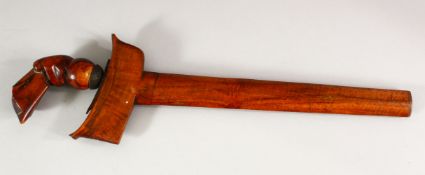 AN INDONESIAN KRIS WITH DAMASCUS BLADE, with carved wood hilt and plain wood scabbard, blade