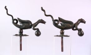 AN UNUSUAL PAIR OF CAST IRON DOOR KNOCKERS, in the form of mythical creatures, both approx. 30cm