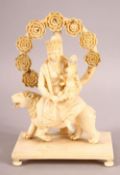 A FINE 19TH CENTURY CARVED IVORY FIGURE OF GODDESS PARVATI HOLDING GANESH, sat upon a lion on a
