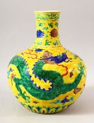 A CHINESE MING STYLE YELLOW GROUND FAHUA VASE, decorated with dragon amongst stylised clouds, 30cm