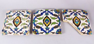 A SET OF THREE EARLY SAFAVID POTTERY TILES, each with the same decoration, white ground ith blue
