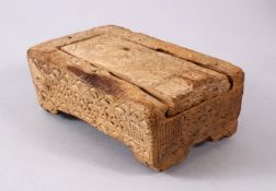 A GOOD EARLY NORTH AFRICAN CARVED WOODEN MAKEUP BOX, carved with African style border and roundel,